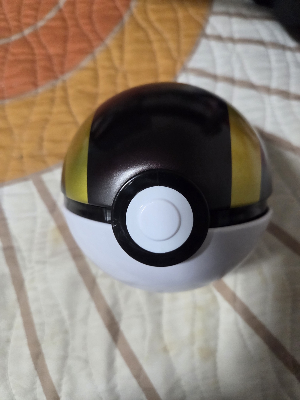 Yellow and White Poké Ball with alot of open pokemon cards